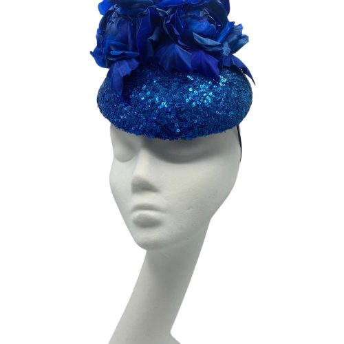 Stunning blue sequinned headpiece with handmade matching blue silk flower detail.